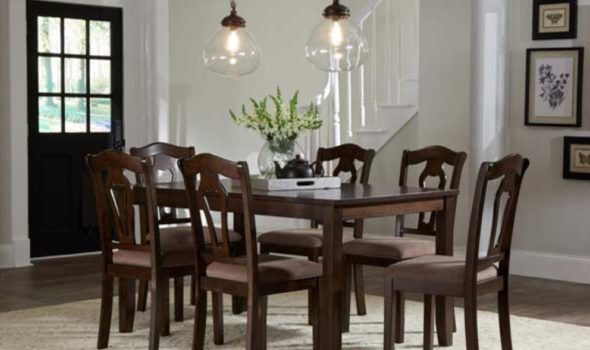 dinning room table with flower vase in center and surrounded by six chairs