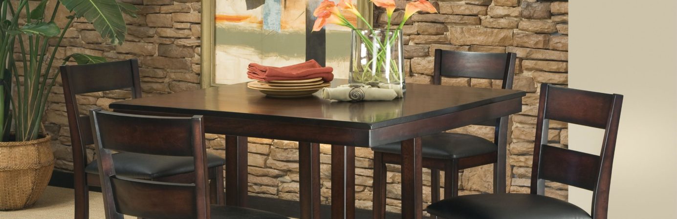 dinning room table with flower vase in center and surrounded by four chairs