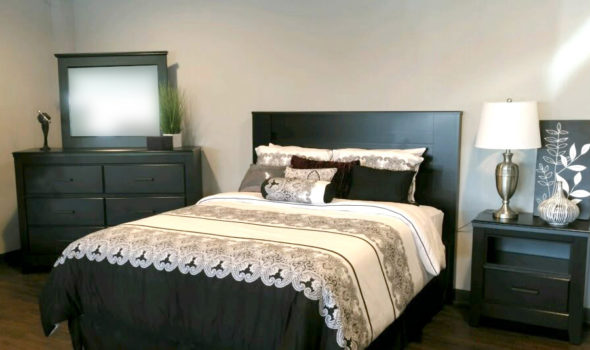 Bedroom setting with bed, bedside table and dresser with mirror