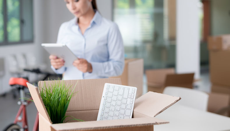 individual packing up boxes to move