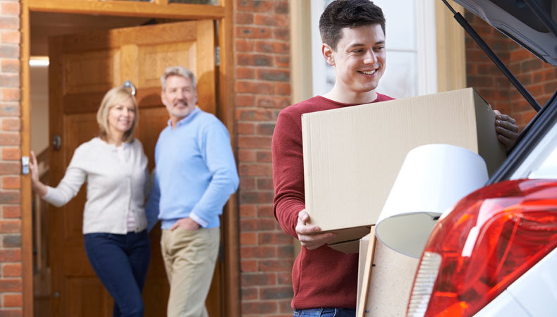 College student packing car with proud parents in background